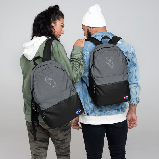 Gray and black champion backpack with an embroidered light gray owl graphic behind a moon