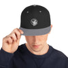 Black baseball hat with logo of a man's face behind the moon