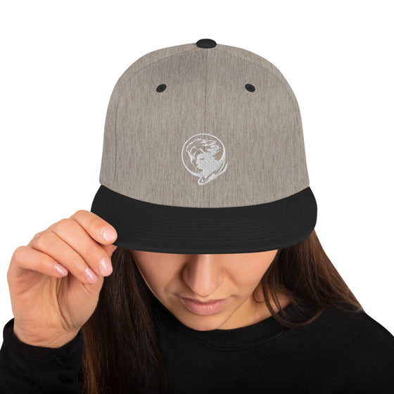 Grey baseball hat with logo of a man's face behind the moon
