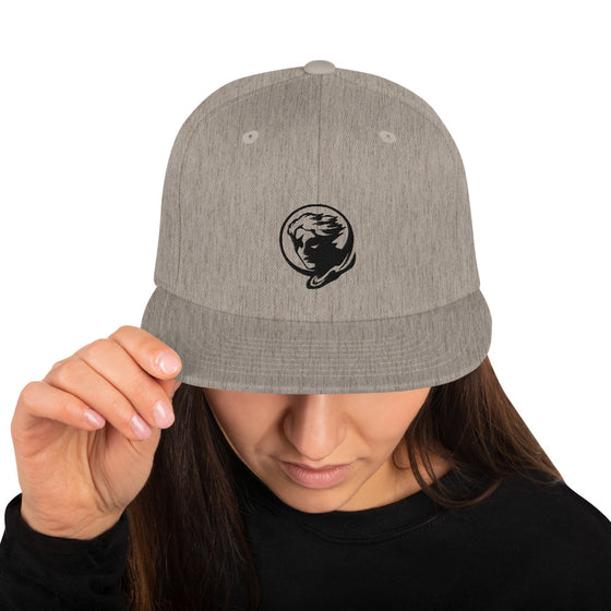 Gray baseball hat with logo of a man's face behind the moon