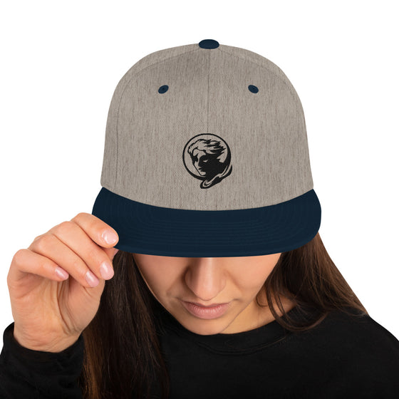 Gray baseball hat with logo of a man's face behind the moon