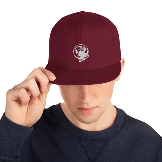 Red baseball hat with logo of a man's face behind the moon