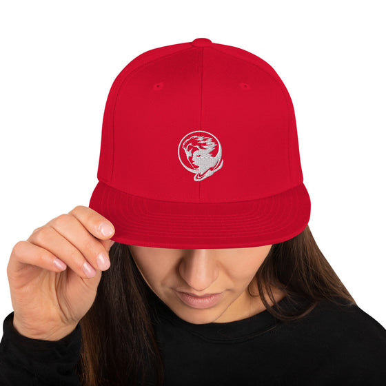 Red baseball hat with logo of a man's face behind the moon
