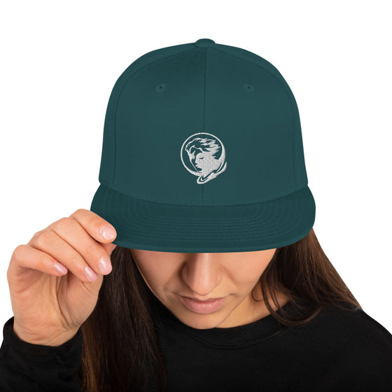 Green baseball hat with logo of a man's face behind the moon