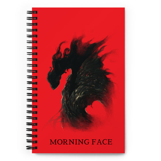 Red notebook with a whispy black alien. Title says MORNING FACE.