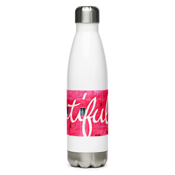 White and silver water bottle with a photograph of a pink wall that says BEAUTIFUL written across.