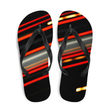  Designer flip flops of red and yellow streaking lights across a black background