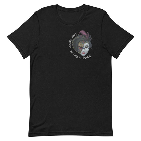 Black graphic shirt of a masquerade mask with the text YOUR FACE IS SHOWING