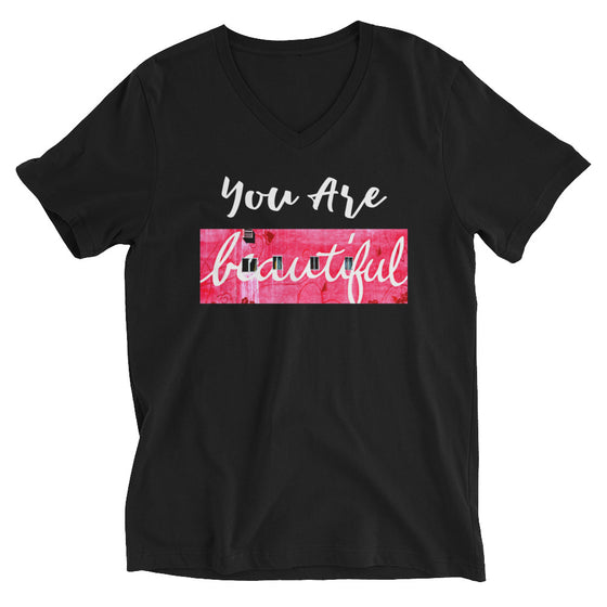 Black vneck t-shirt that says YOU ARE BEAUTIFUL with a photograph of a pink wall behind beautiful
